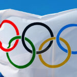 White Olympics Flag against the blue sky in Athens