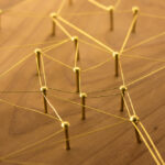 Web of gold wires on rustic wood